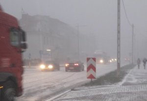 samochody jadące po zaśnieżonej drodze