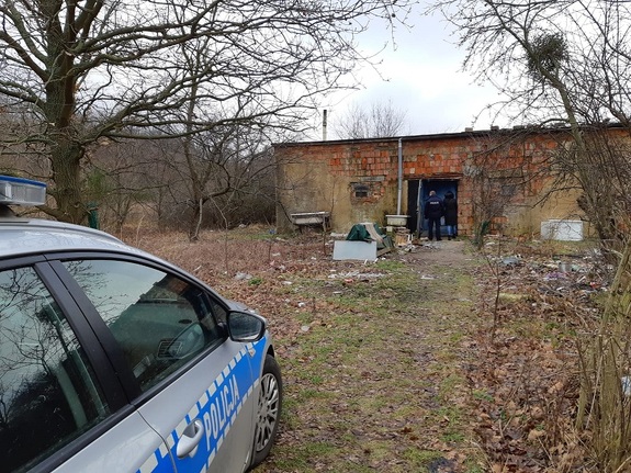 pustostan i zaparkowany przed nim radiowóz policyjny